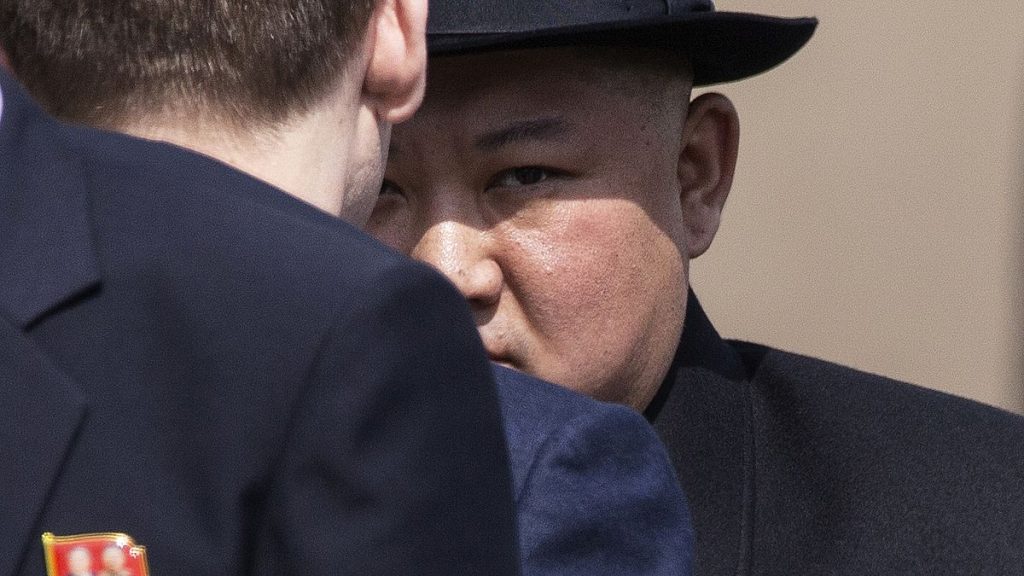 North Korean leader Kim Jong Un, background attends a leaving ceremony at the main train station in Vladivostok, Russia