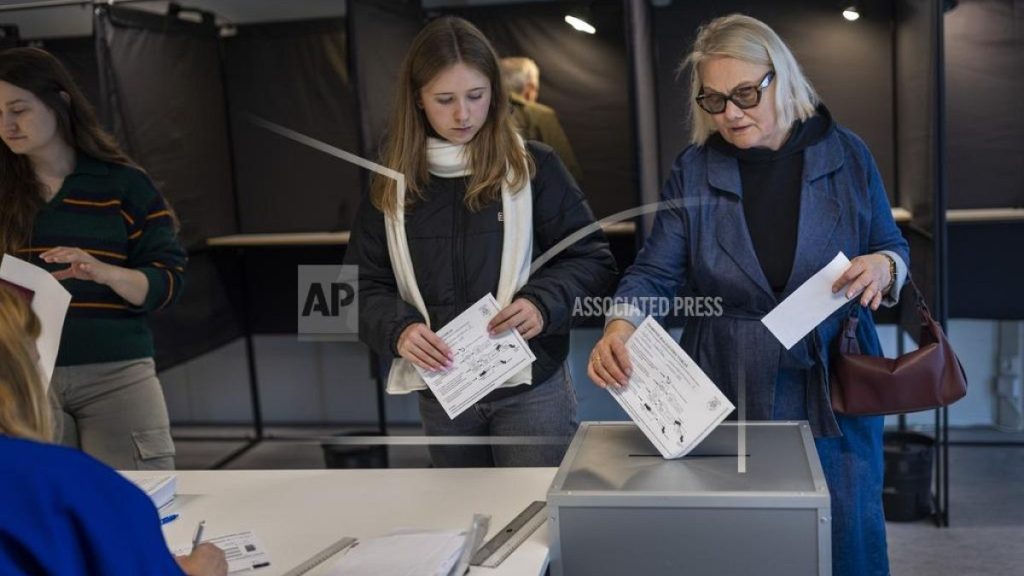 Local residents vote at a polling station during the advance voting in the second round of a parliamentary election in Vilnius, Lithuania, Tuesday, Oct. 22, 2024.