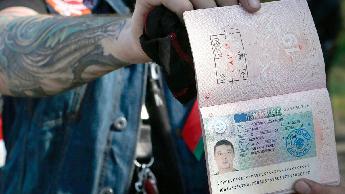 FILE: Belarusian biker shows his cancelled visa after returning from Polish border check point in Brest, 27 April 2015