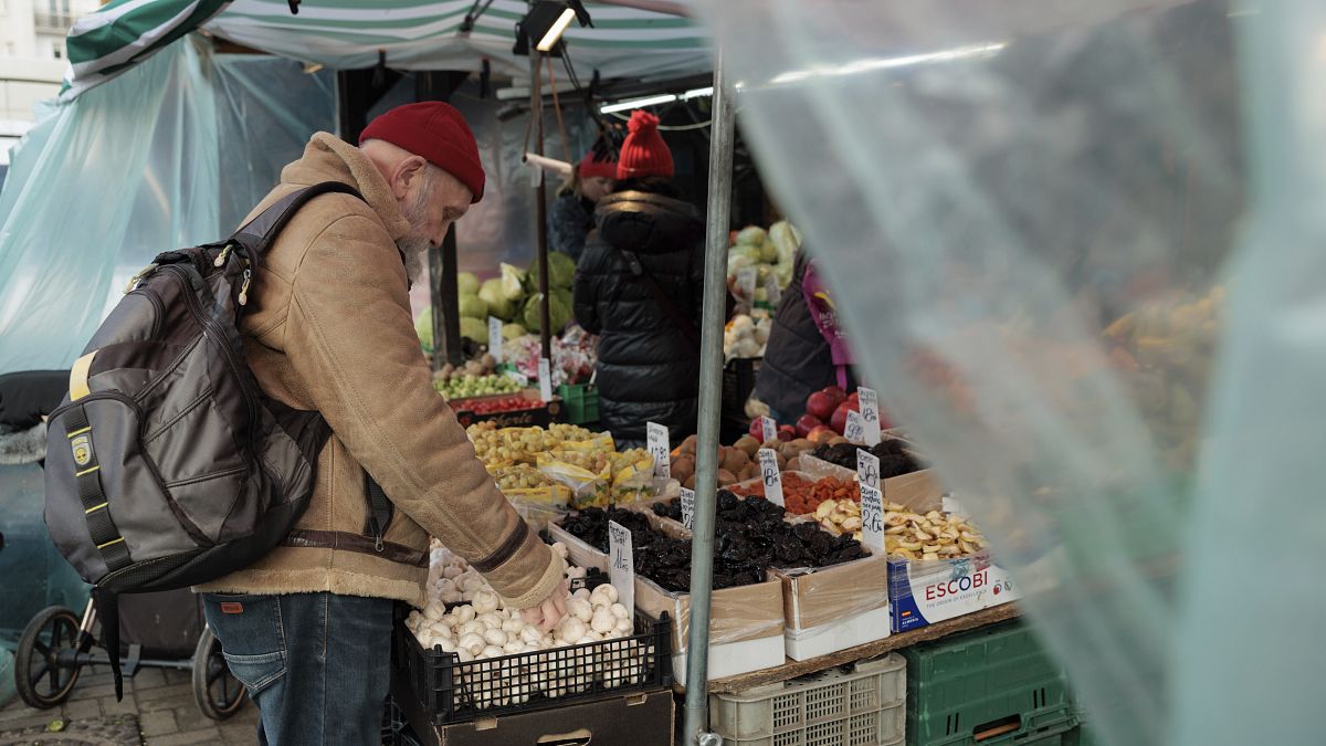 A man shops at an outdoor vegetable stand at the Hala Mirowska market in Warsaw.