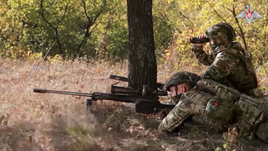 In this image made from video released by the Russian Defense Ministry on Friday, Oct. 11, 2024, a Russian sniper, in an undisclosed location, fires towards Ukrainian forces.