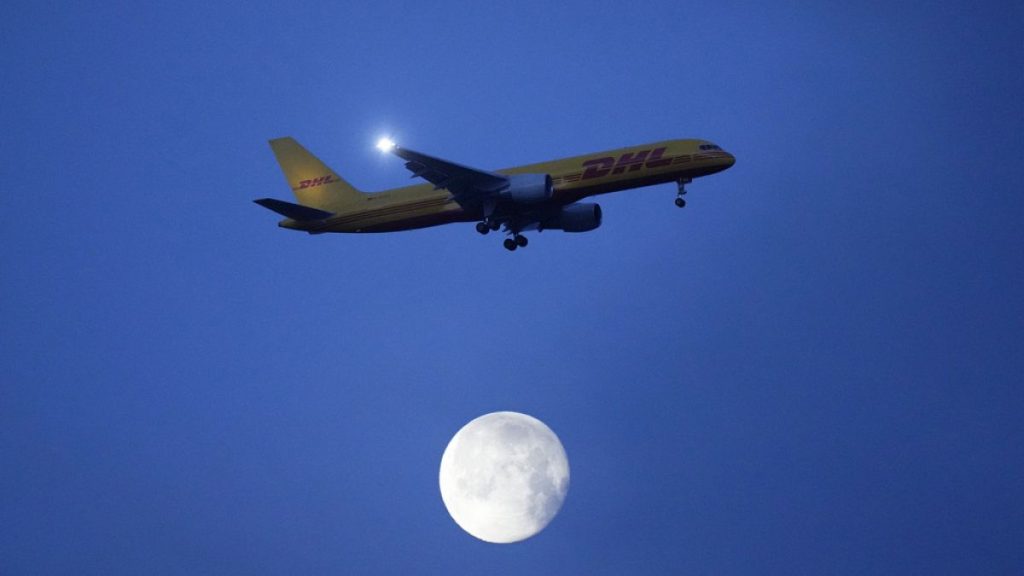 A DHL Boeing 757 approaches for landing in Lisbon just before sunrise, Monday, Feb. 26, 2024.