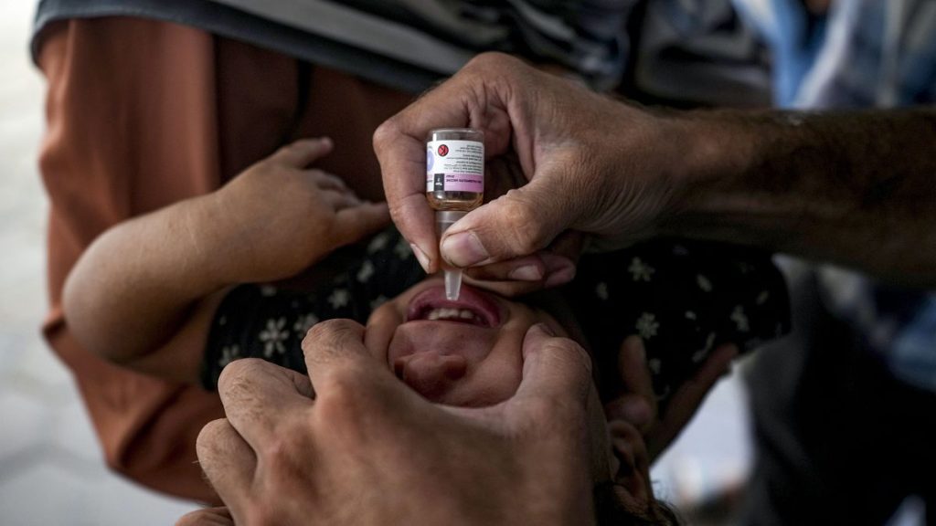 A health worker administers a polio vaccine to a child at a hospital in Deir al-Balah, central Gaza Strip, Sunday, Sept. 1, 2024.