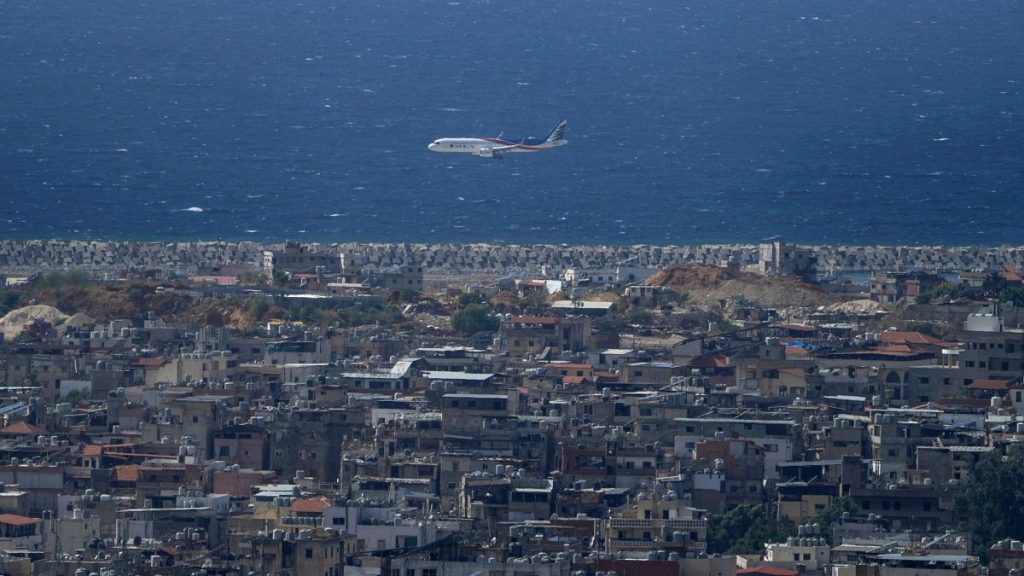 A Middle East Airlines airplane flies over Dahiyeh, in Beirut, Lebanon, Tuesday, 1 October 2024