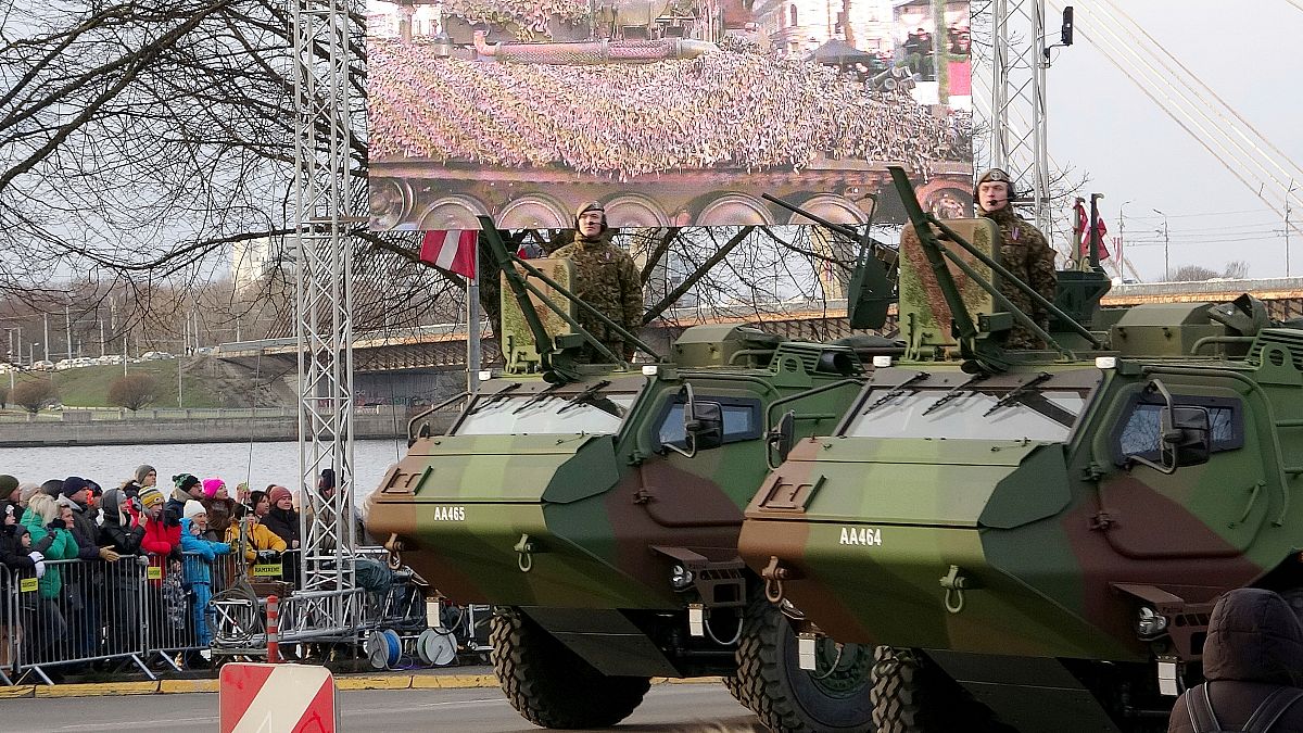 FILE - Latvian Army armoured carriers ride during a military parade on Latvian Independence Day, in Riga on Friday, 18 November, 2022.