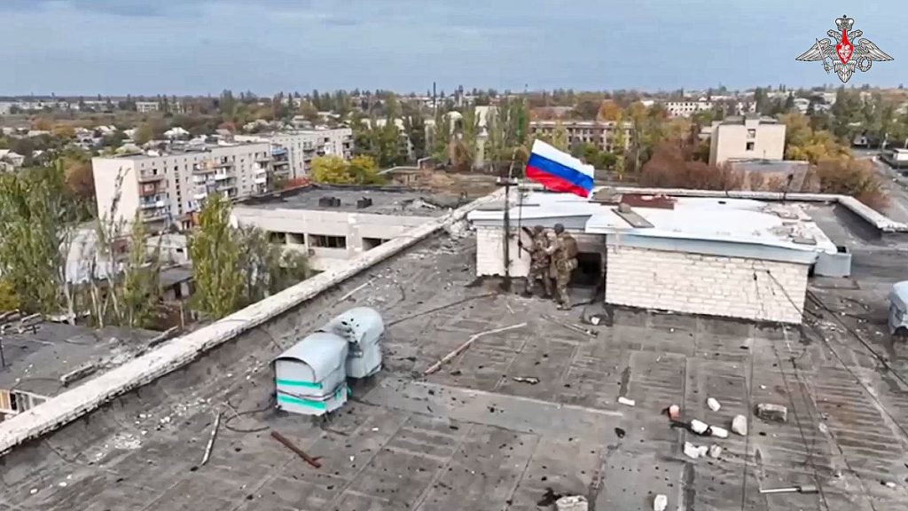 In this photo taken from video distributed by Russian Defense Ministry Press Service on Wednesday, Oct. 30, 2024, Russian troops hoist Russia