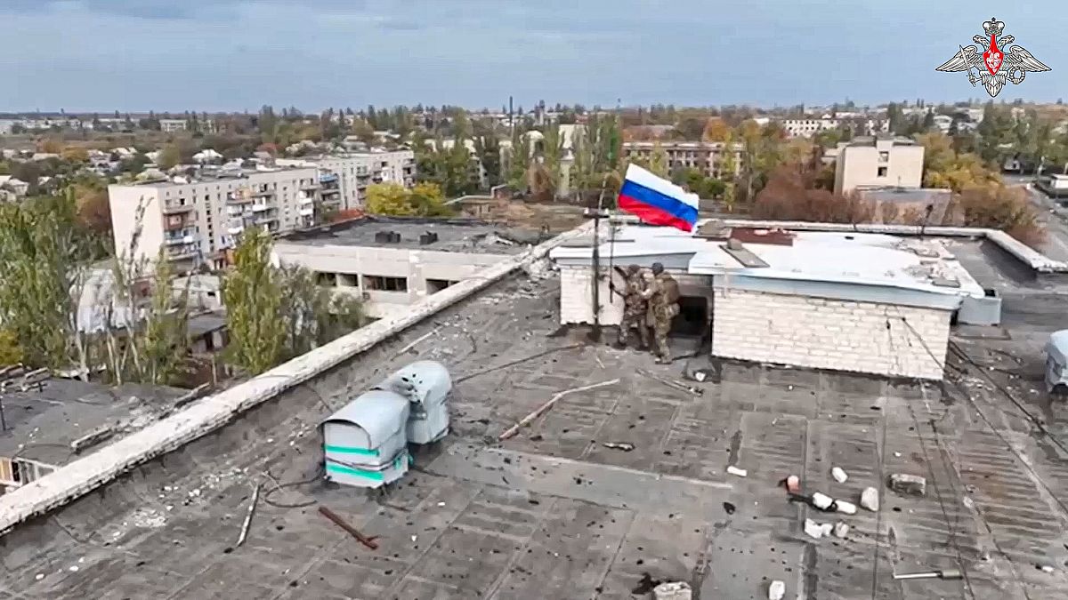 In this photo taken from video distributed by Russian Defense Ministry Press Service on Wednesday, Oct. 30, 2024, Russian troops hoist Russia