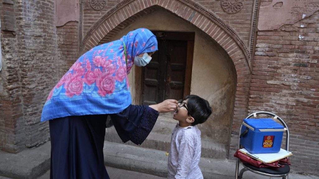 A health worker administers a polio vaccine to a child in Pakistan in October 2024.