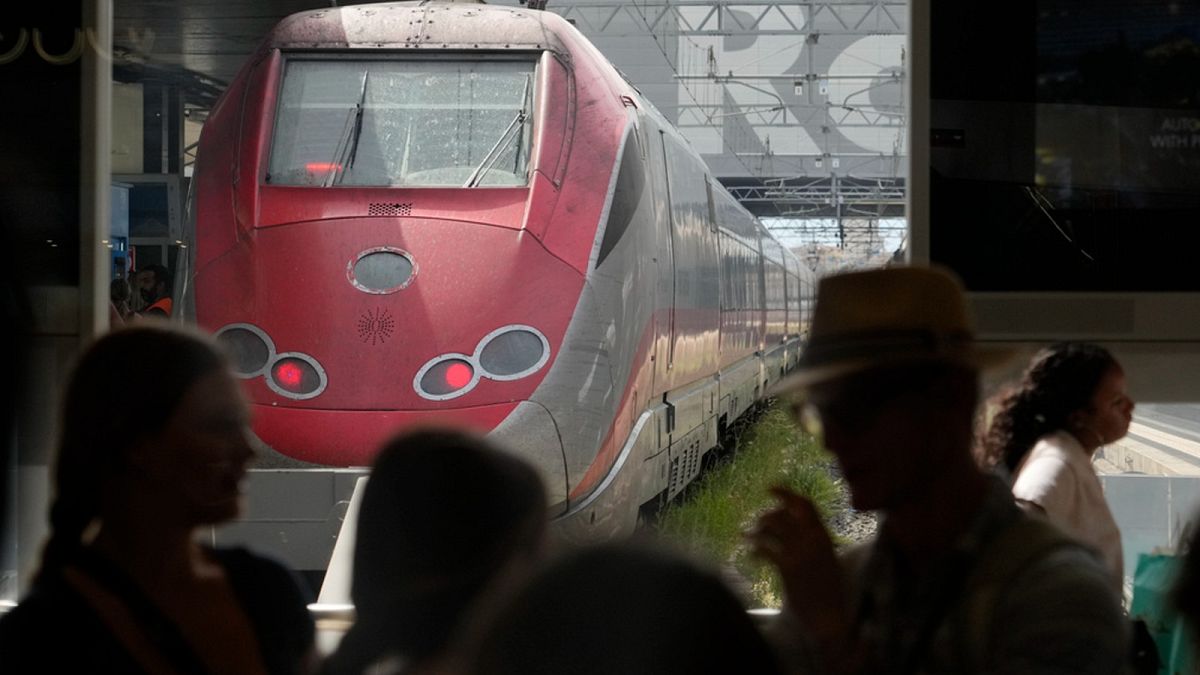 Passengers wait for their trains at Rome