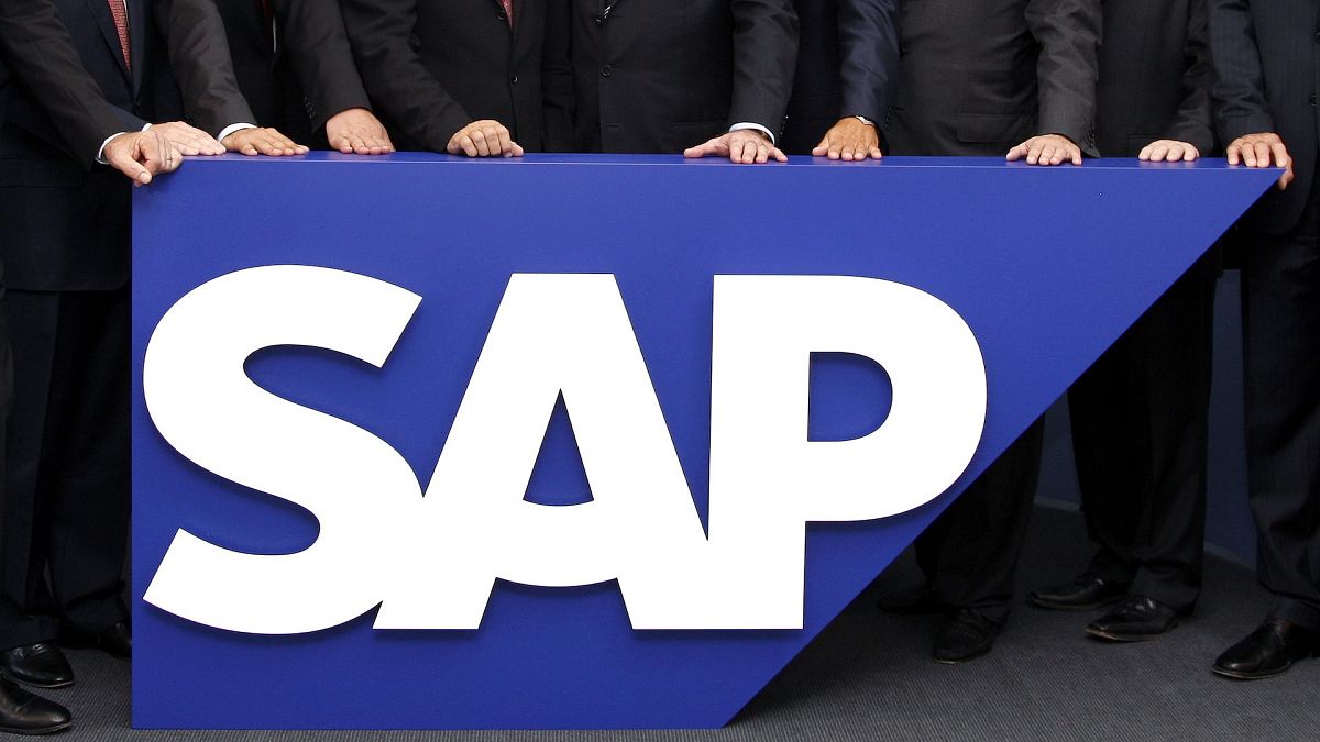 The board members of German software company SAP stand behind the company logo at its headquarters in Walldorf near Heidelberg