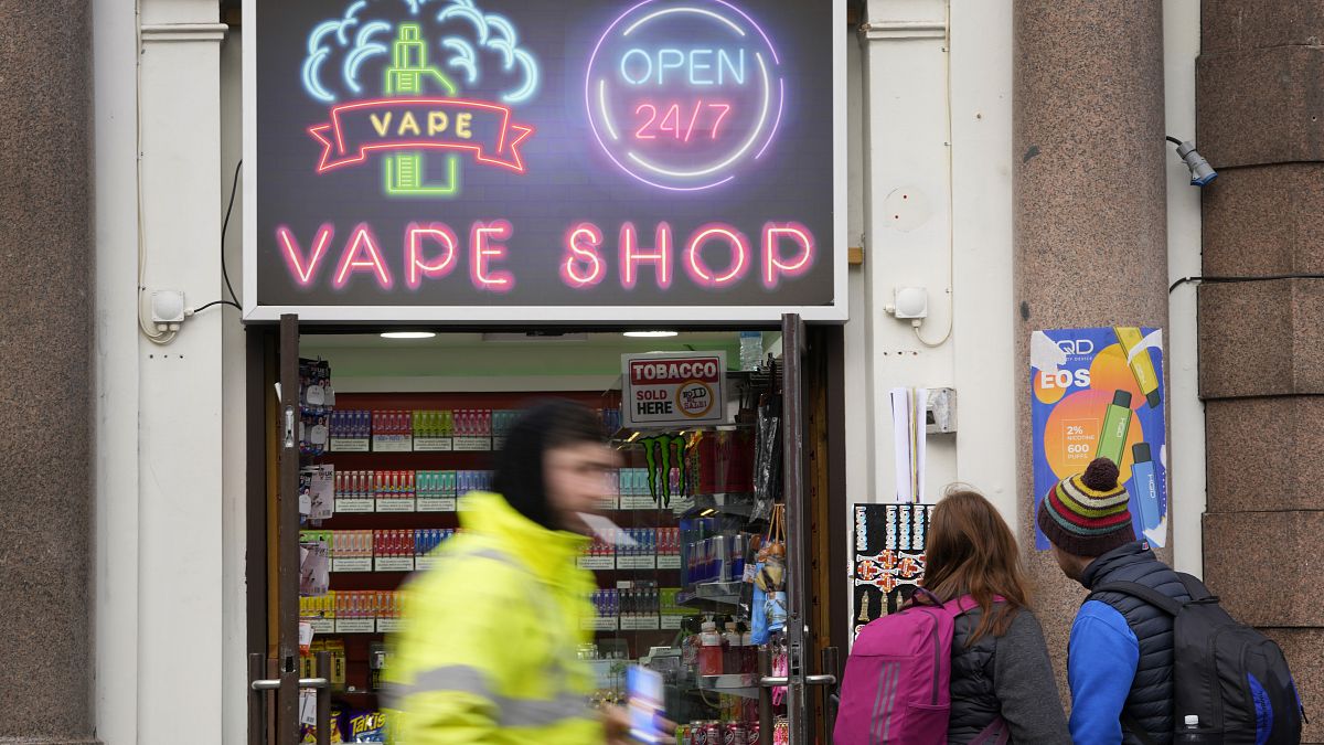 Pedestrians pass a vape shop in London, Monday, January 29, 2024.