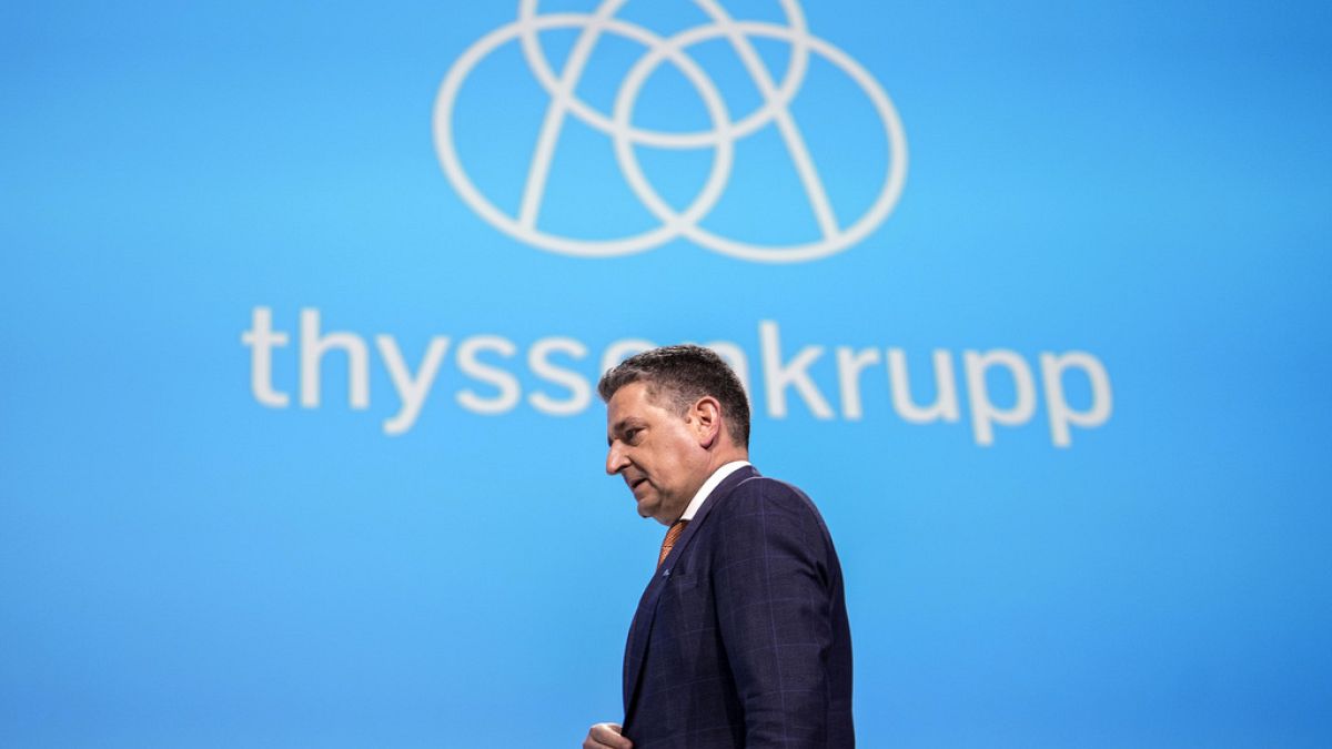 New CEO of ThyssenKrupp AG, Miguel Angel Lopez Borrego, center, walks under the company logo at the annual meeting of the steelmaker in Germany, Feb. 2, 2024.