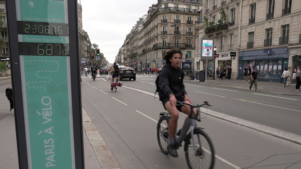 A man rides past a bicycle counter in Paris, Wednesday, 13 September 2023