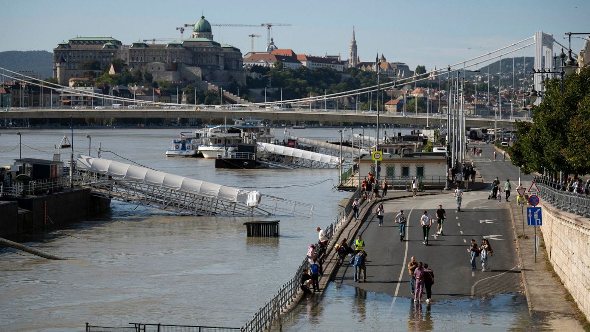 People gather in the quayside of Budapest as the Danube river overflowed its banks in central Budapest, Hungary, 20 September 2024.