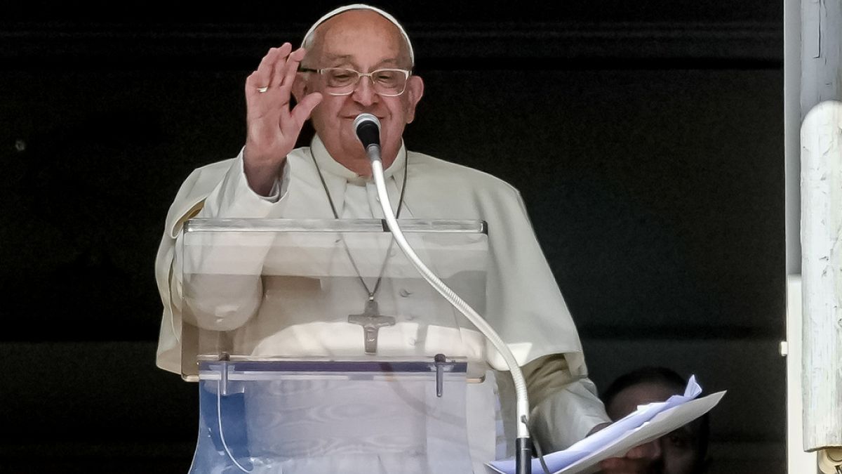 Pope Francis appears at his studio window for the traditional noon blessing of faithful and pilgrims gathered in St. Peter