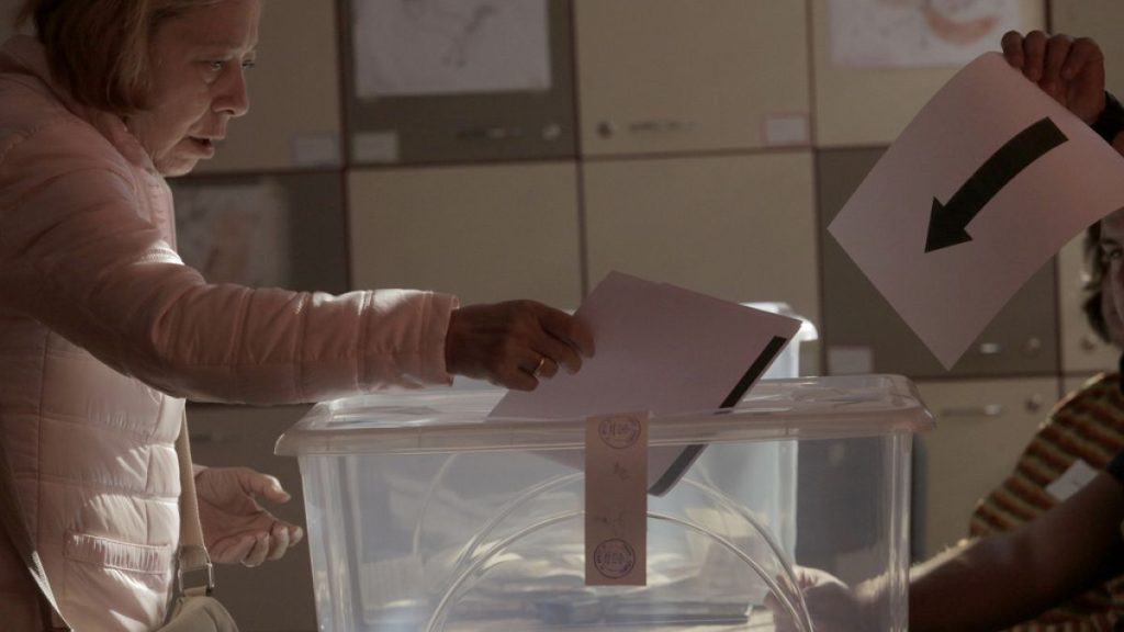 A woman holds his ballot at a polling station during the general elections in Sofia, Sunday, Oct. 27, 2024