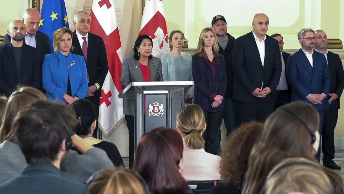 Georgian President Salome Zourabichvili, center, surrounded by opposition leaders speaks to the media after the parliamentary election in Tbilisi, Georgia, on Sunday, Oct. 27,