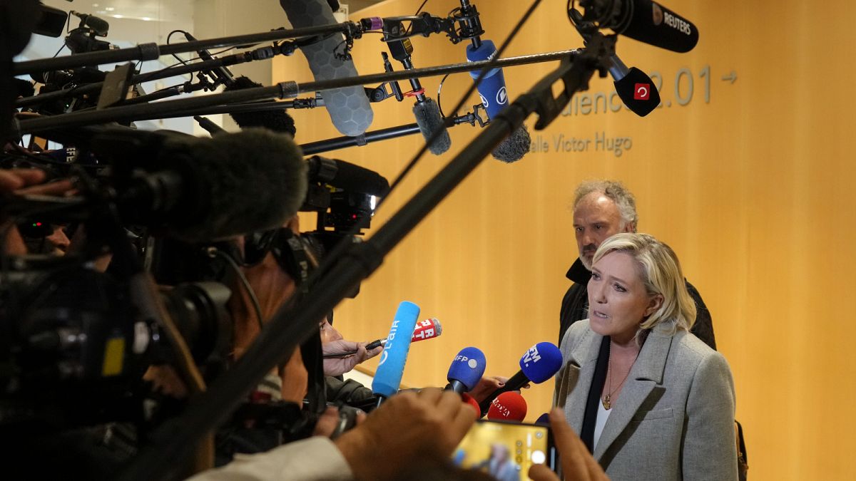 Marine Le Pen arrives with her lawyer Rodolphe Bosselut at a trial over misuse of EU funds.