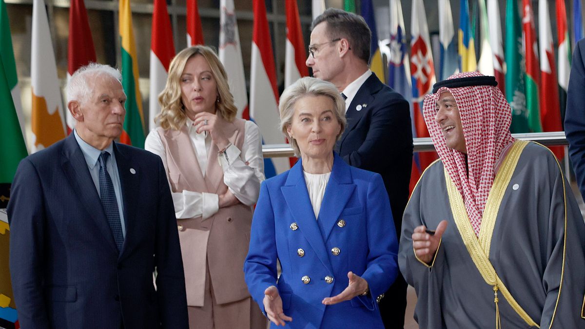 Participants speak during a group photo at an EU-Gulf Cooperation Council meeting in Brussels, 16 October 2024