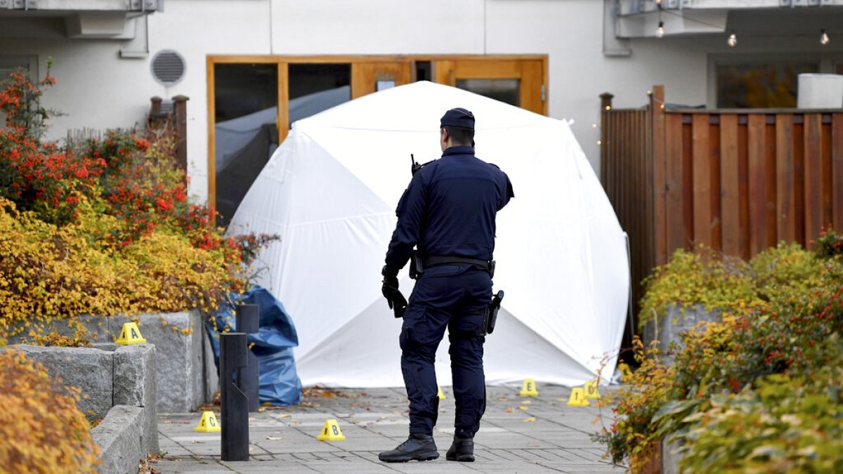 Forensic police stand at the scene where Swedish rapper Einar was shot to death, in Hammarby Sjostad district in Stockholm, Friday, Oct. 22, 2021