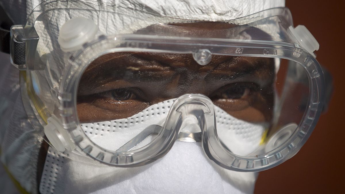 A medical worker in full protective equipment prepares to enter an isolation tent housing a man being quarantined after being in contact with a carrier of the Marburg Virus.