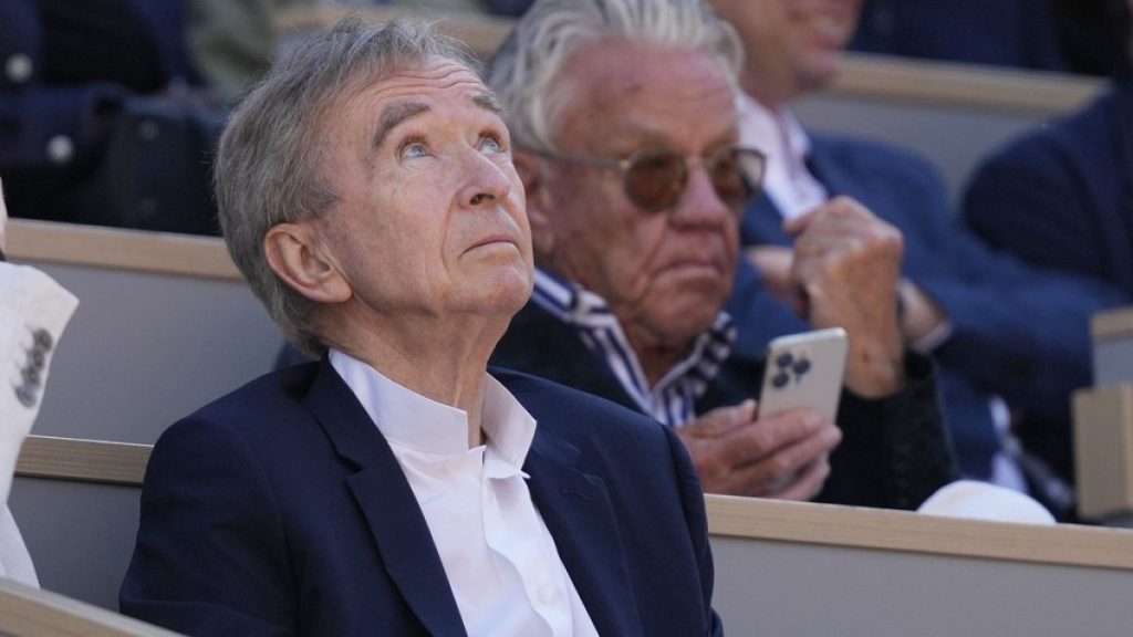 LVMH luxury group CEO Bernard Arnault watches the men