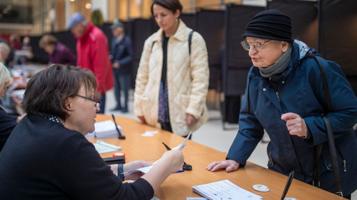 A woman arrives at a polling station during advance voting in the first round of a parliamentary election in Vilnius, Lithuania, on Wednesday 9 October, 2024.