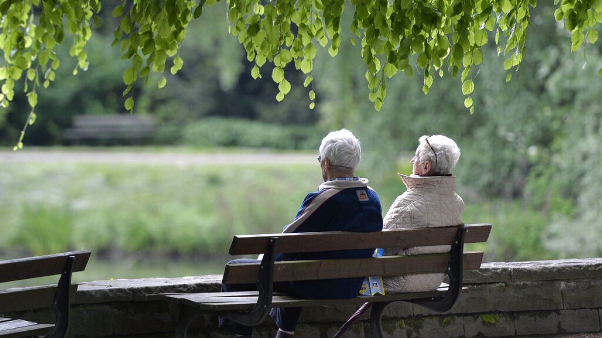 An elderly couple sits on a bench in a park in Gelsenkirchen, Germany, Wednesday, May, 14, 2014.