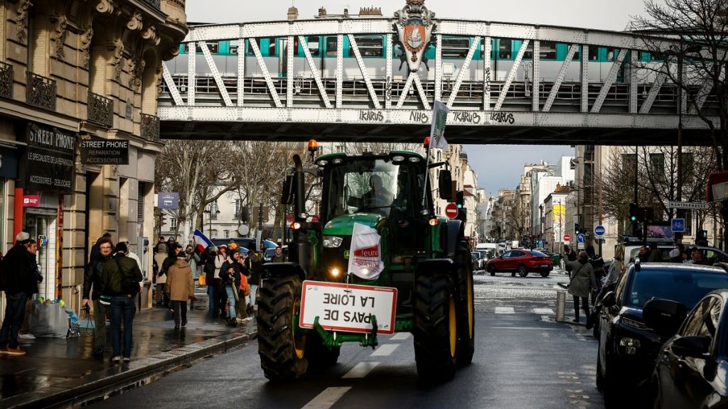 A farmer drives his tractor during a protest on Friday, 23 February 2024 in Paris.