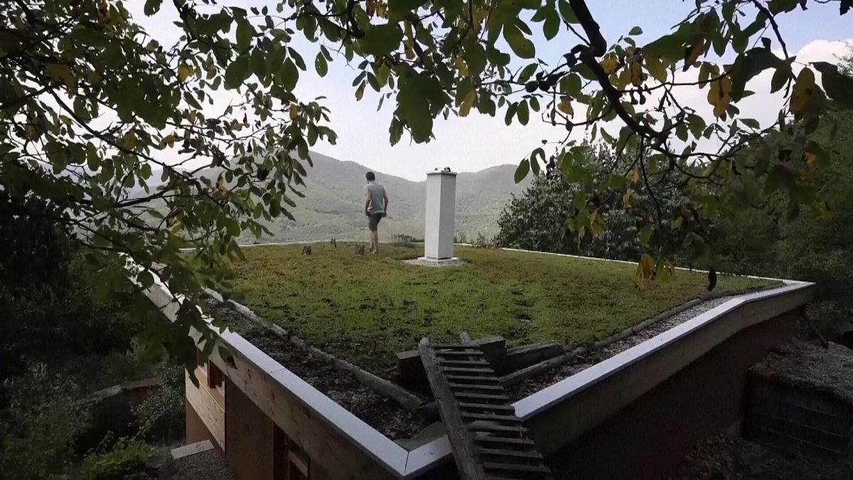 Architect Kamen Pramatarov walking on green roof of his house in village of Zhelen.