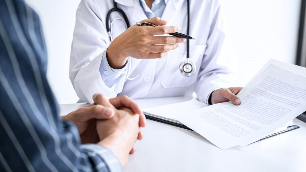 A doctor consults with a patient.