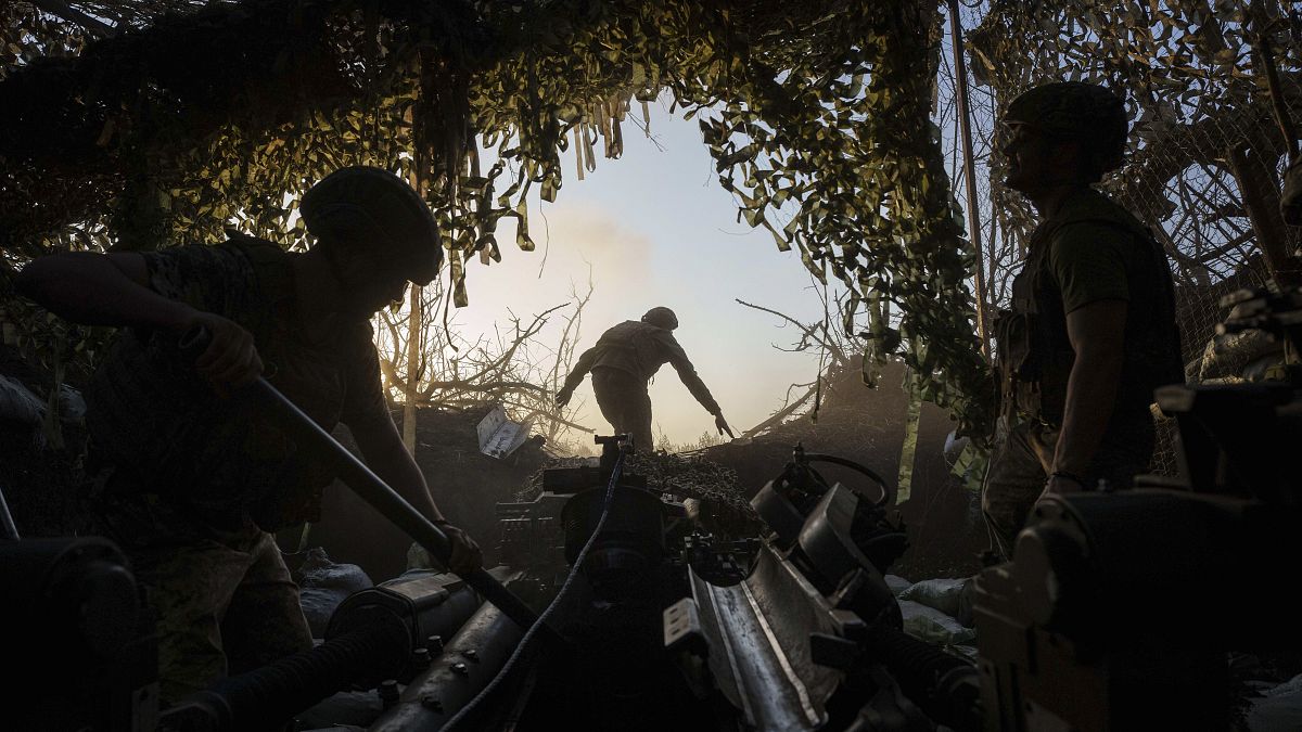 Ukrainian servicemen of 148th separate artillery brigade of the Air Assault Forces prepare a M777 howitzer to fire towards Russian positions at the frontline in Donetsk region