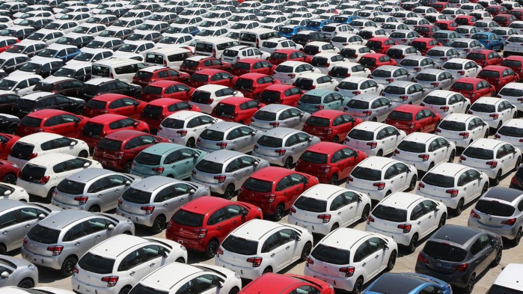 Multiple rows of parked cars in a parking lot