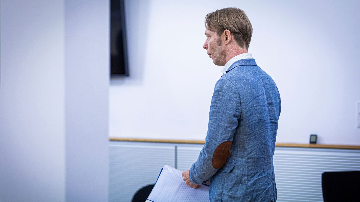 Christian B., accused of three cases of aggravated rape and two cases of sexual abuse of children in Portugal, enters a courtroom in Brunswick, Germany.