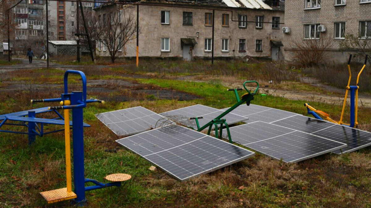 FILE - Solar panels seen in the yard of an apartment building in Lyman, Donetsk region, Ukraine, on Sunday, 20 November, 2022.