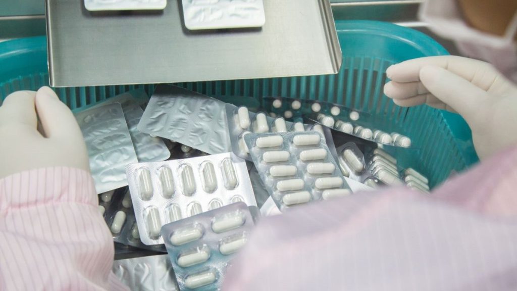 A health worker reviews medicines.