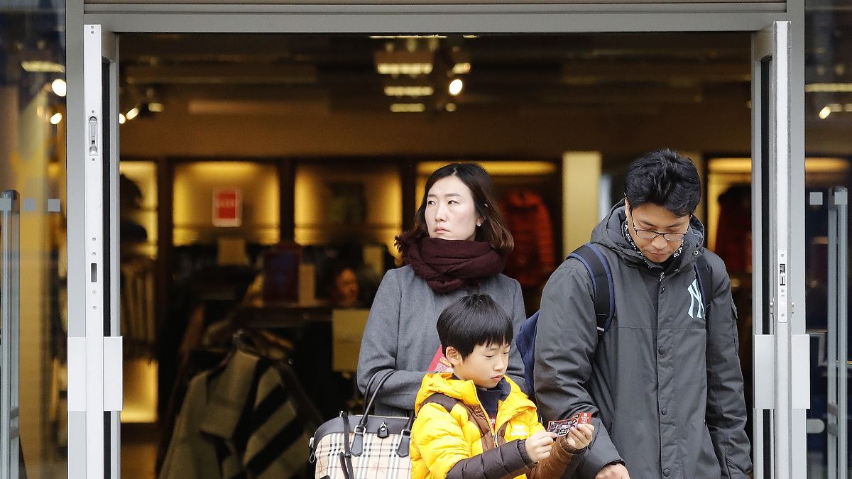 Library picture of overseas shoppers leaving a Burberry shop in central London