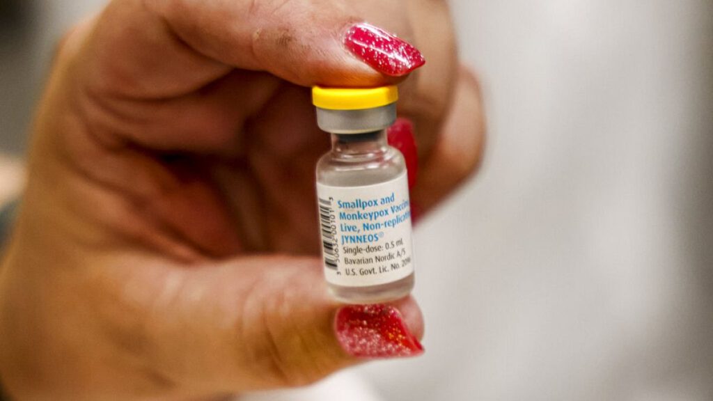 A nurse holds a vial containing the mpox vaccine.