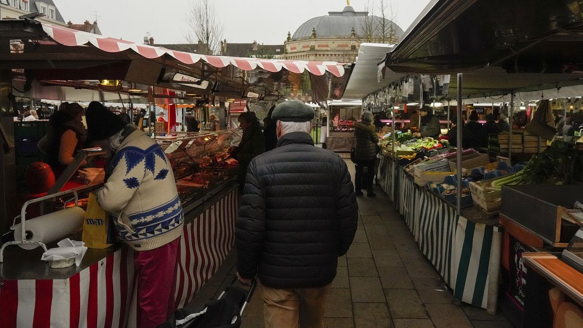 People shop at an open air market in Fontainebleau, south of Paris