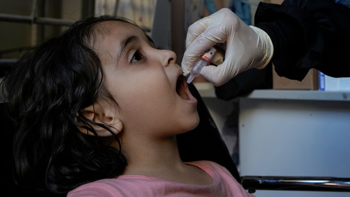 Angelina, who is fleeing the Israeli airstrikes with her family from Dahiyeh, receives a polio vaccine in Beirut, Lebanon. October 9, 2024.