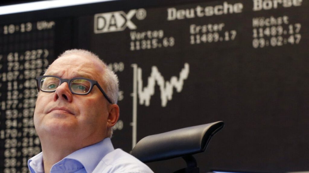 A trader watches his screens at the stock market in Frankfurt, Germany, Monday, July 13, 2015