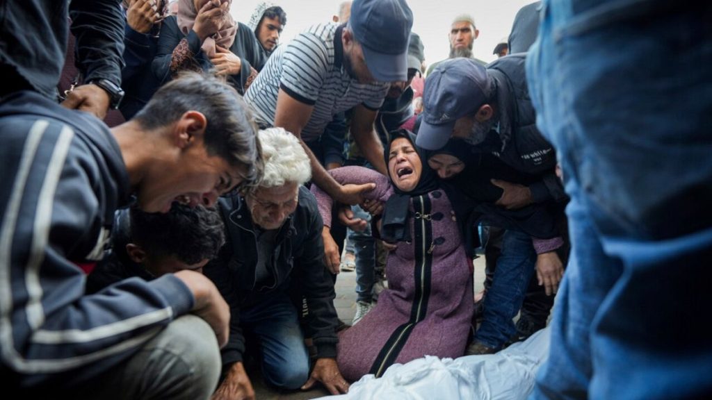 Palestinians mourn their relatives killed in the Israeli bombardment of the Gaza Strip at a hospital morgue in Deir al-Balah, Tuesday, Oct. 29, 2024.