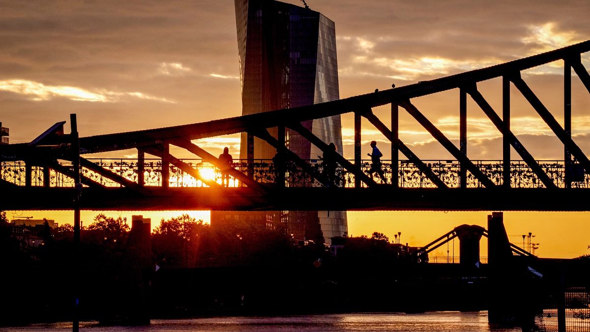 The sun rises next to the European Central Bank in Frankfurt, Germany