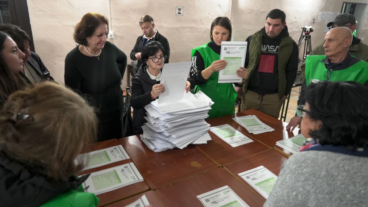 Members of an election commission count ballots at a polling station after the parliamentary election in Tbilisi, Georgia, Saturday, Oct. 26, 2024