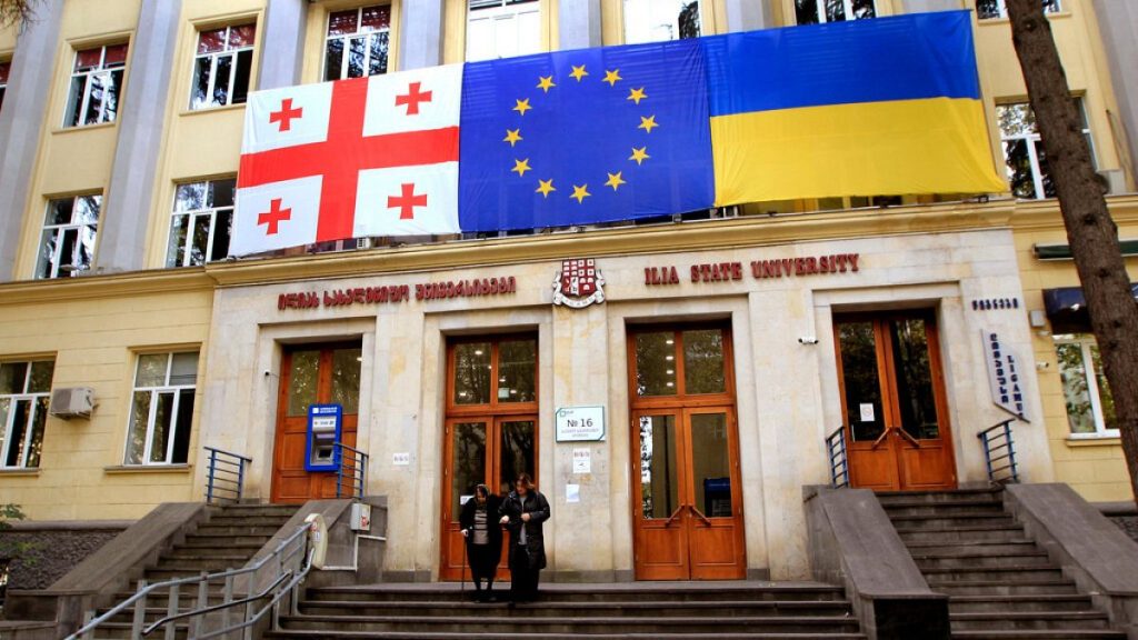 Georgian national, EU and Ukrainian national flags hangs at a polling station during the parliamentary election in Tbilisi, Georgia, Saturday, Oct. 26, 2024.