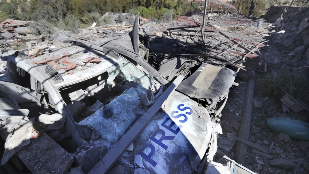 Destroyed vehicles used by journalists at the site where an Israeli airstrike hit a compound housing journalists, killing three media staffers from two different news agencies