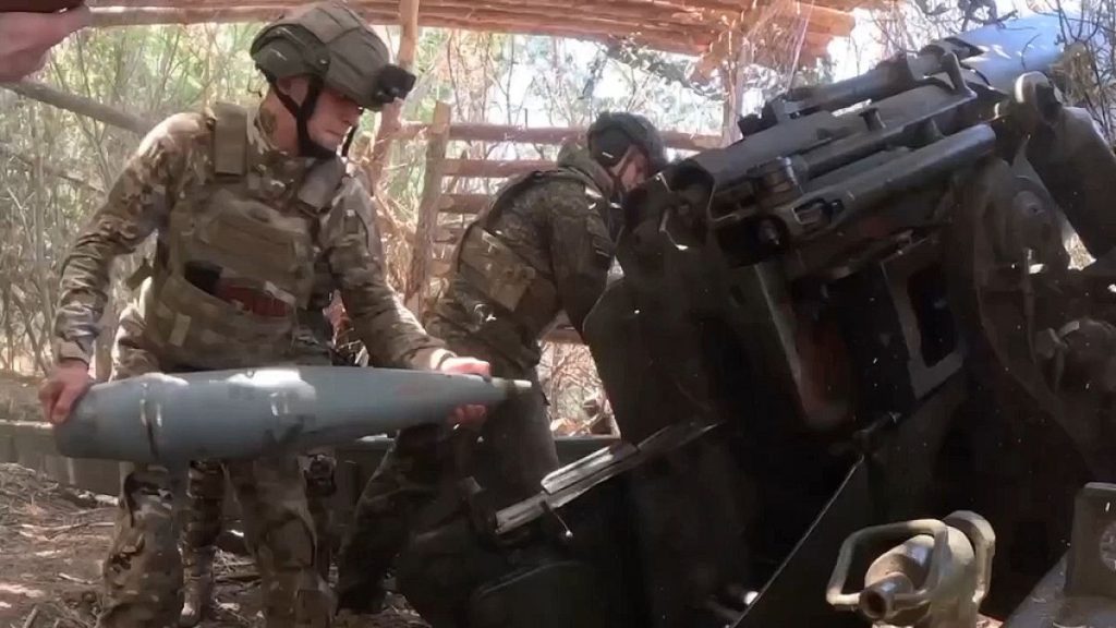 Russian soldiers fire a Giatsint-B gun towards Ukrainian positions at an undisclosed location in Ukraine