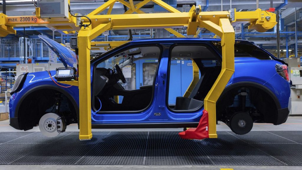 Ford Explorer electric cars stand in the hall at the start of production, in Cologne, Germany, Tuesday June 4, 2024. This is the first electric car produced by Ford in Europe.