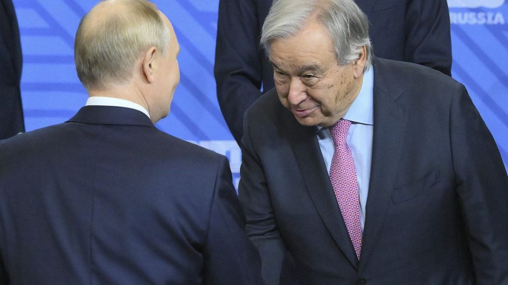 Russian President Vladimir Putin, left, and United Nations Secretary-General Antonio Guterres shake hands during BRICS summit in Kazan, Russia,