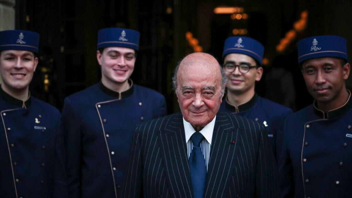 Egyptian businessman and Ritz owner Mohammed Al Fayed poses with his hotel staff for a photograph, in Paris, Monday, June 27, 2016.